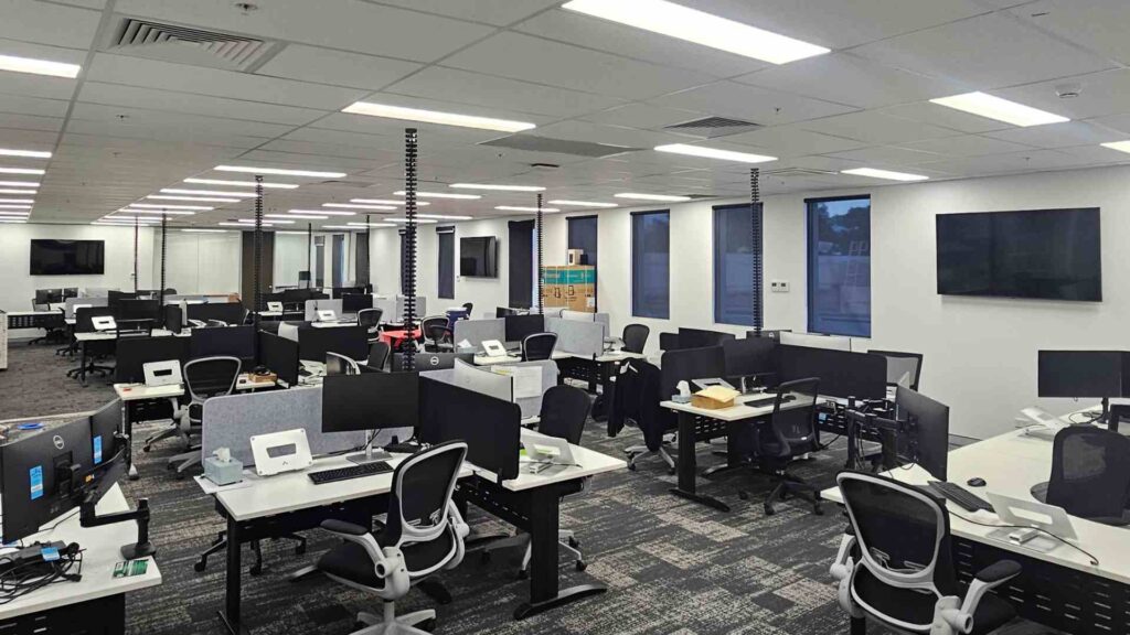 This image displayed a well-organized office with desktops and structured cabling after an expert Electrical
