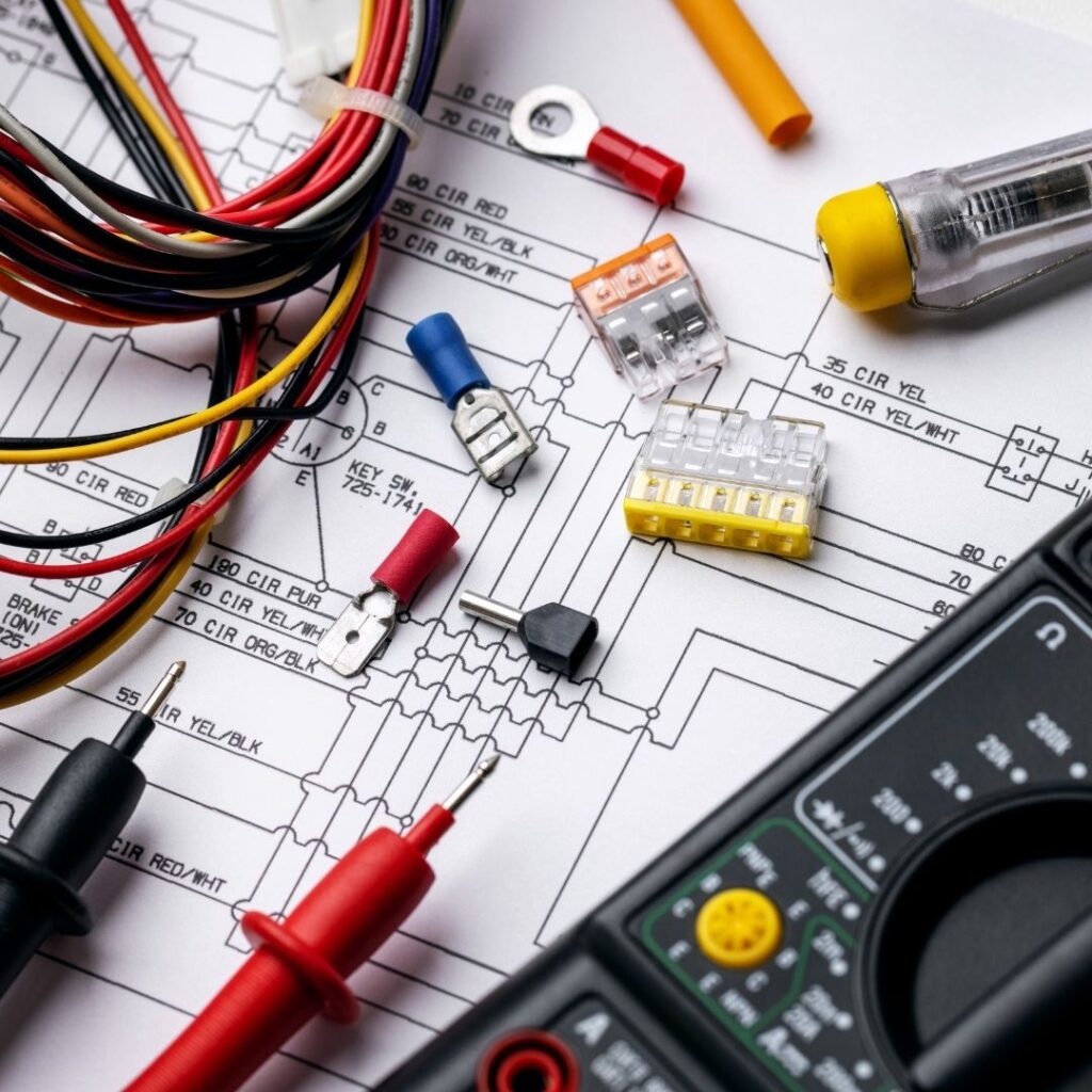 A detailed electrical circuit diagram with wiring, connectors, a multimeter, and testing tools used by a professional Electrician in Haymarket for business electrical installations and repairs.