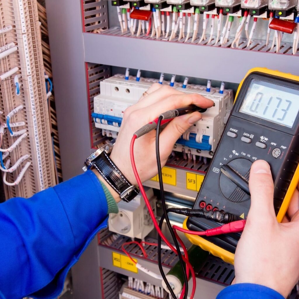 A certified Electrician in Ultimo conducting a detailed electrical test on a circuit breaker panel to ensure safety and system reliability.