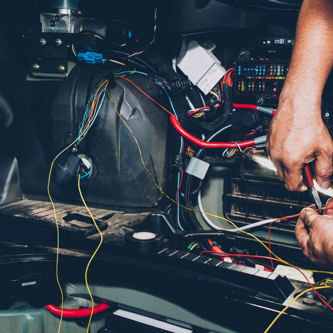 A professional electrician working on complex wiring and circuit connections, ensuring safe and efficient Commercial Electrical Services Sydney for businesses.