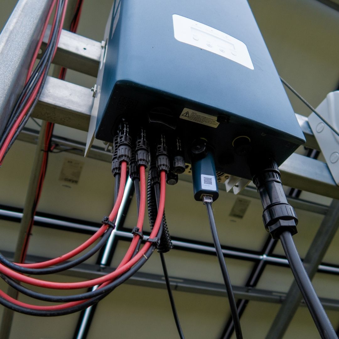 A close-up of an electrical panel with multiple cables connected, showcasing a power installation for an industrial or renewable energy system.
