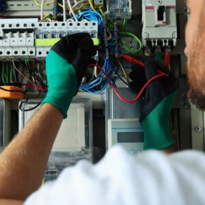 A professional electrician performing electrical panel testing, ensuring reliable Commercial Electrical Services Sydney for business safety and efficiency.