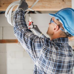 A professional electrician Dawes Point installing ceiling wiring for a commercial building, ensuring a reliable and safe electrical system.