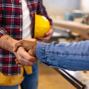 A handshake between a business owner and a Commercial Electrical Contractor in Sydney, symbolizing trust, reliability, and professional electrical service for commercial projects.
