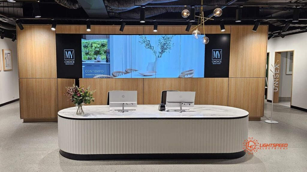 A polished reception space featuring bespoke lighting and display solutions installed by Lightspeed Electrical commercial electrician.