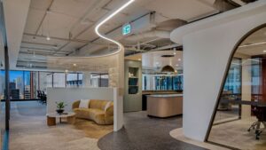 This image shows a completed office fit-out in Sydney featuring integrated ceiling lights and a refined modern workspace