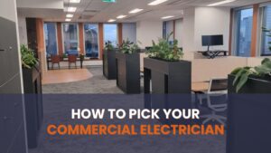 Choose your best commercial electrician: A clean, modern open-plan office environment showing high-end cubicle dividers, task lighting, and power outlets necessary for a large staff. This environment depends entirely on flawless electrical infrastructure. The instructional text, "HOW TO PICK YOUR COMMERCIAL ELECTRICIAN", positions the company as an authority on choosing the best commercial electrician for complex and professional business environments.