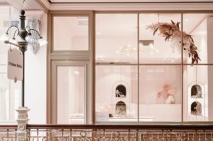 Retail lighting design. Warm display lighting highlighting bridal shoes and accessories in a boutique window.