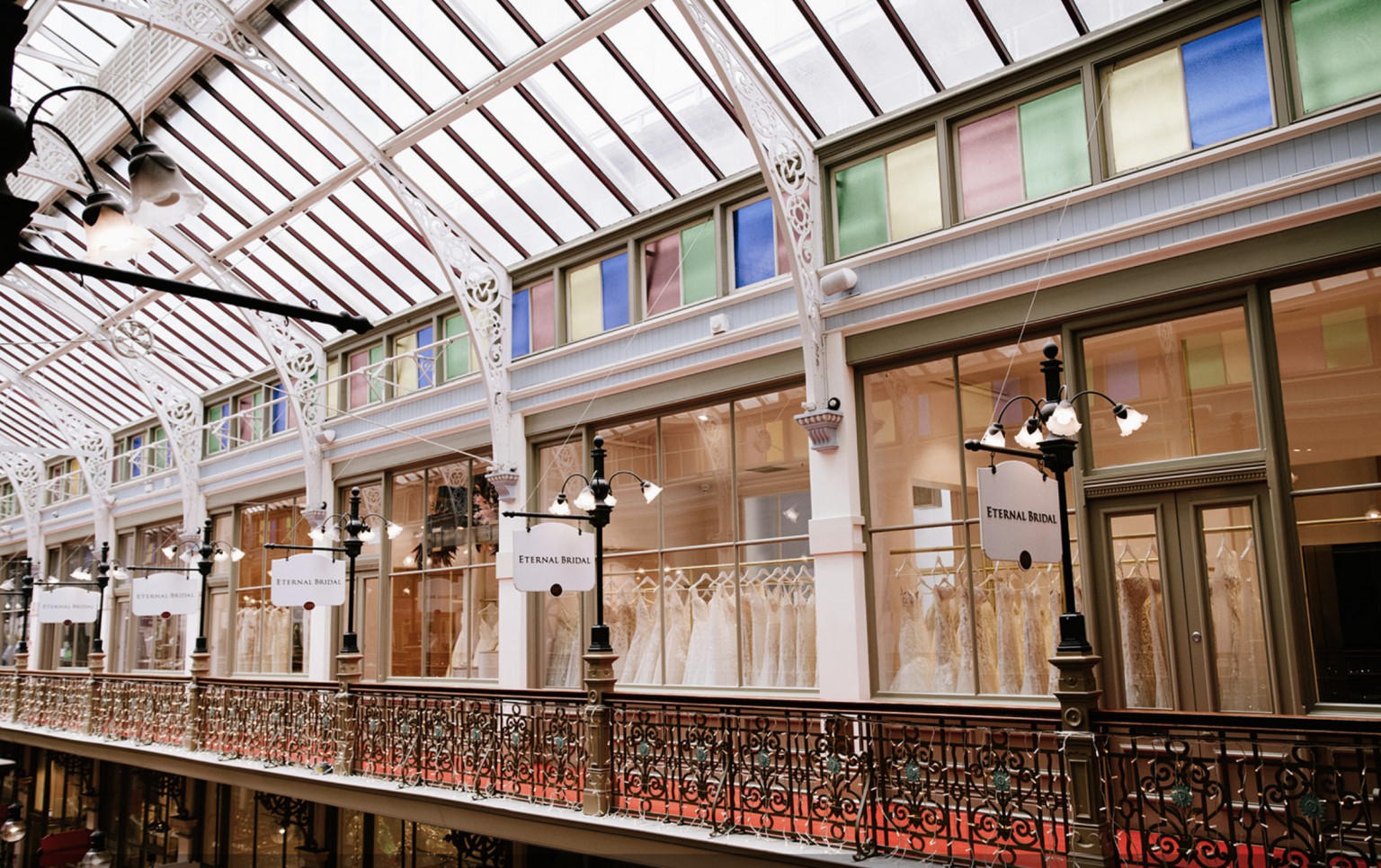 Victorian-style street lamps and natural skylight integration for retail lighting design.