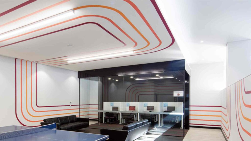 Lightspeed commercial electricians in Sydney conducting intricate data cabling and general power wiring installations, focusing on modern suspended pendant and tracked ceiling lights.
