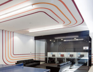 Commercial breakroom with linear LED lighting fixtures and glass partitions highlighting facility fit-out work in a commercial vs industrial electrician project breakdown, by Lightspeed Electrical.